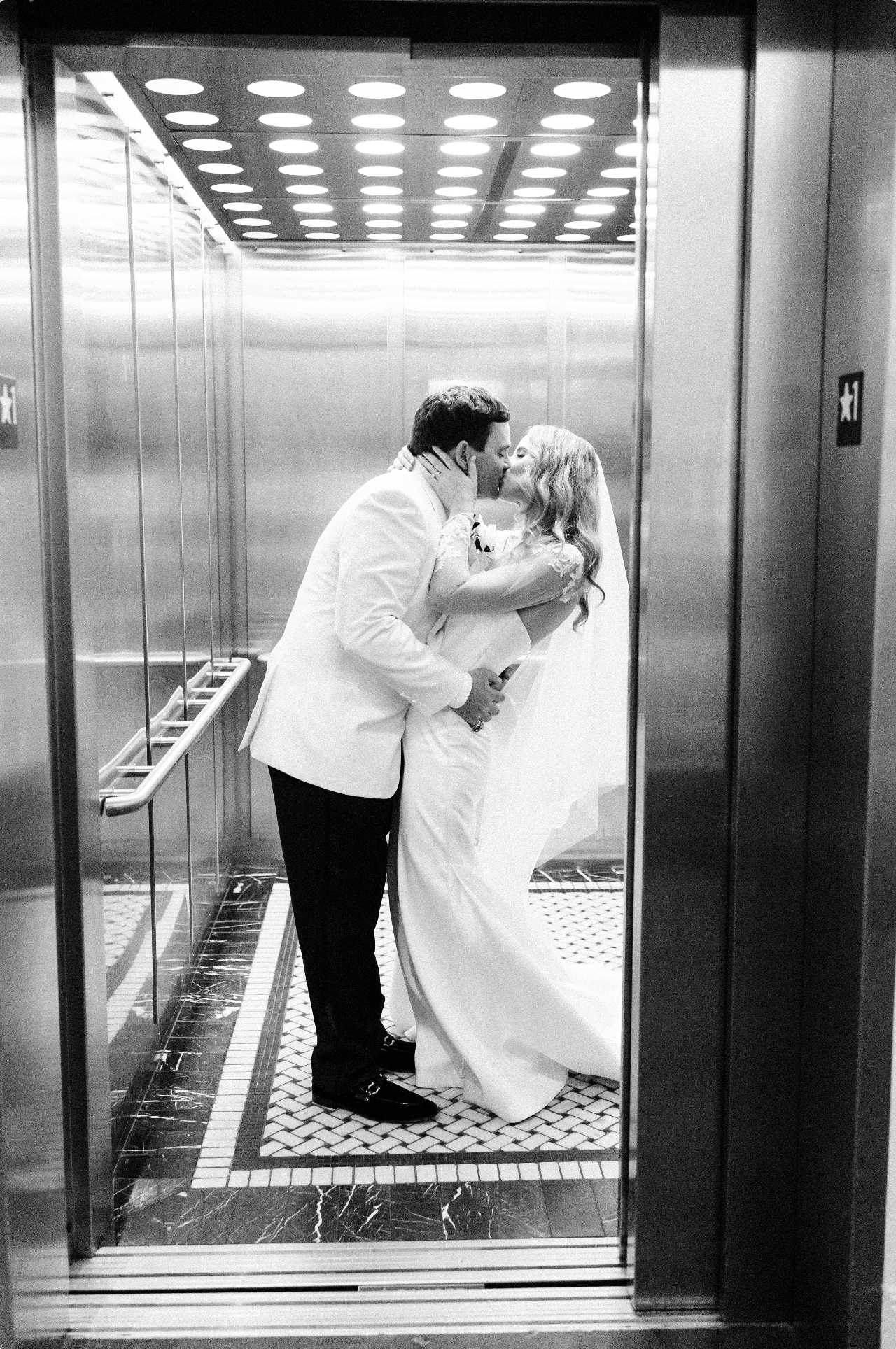 Newlyweds kiss in the elevator at 701 Whaley