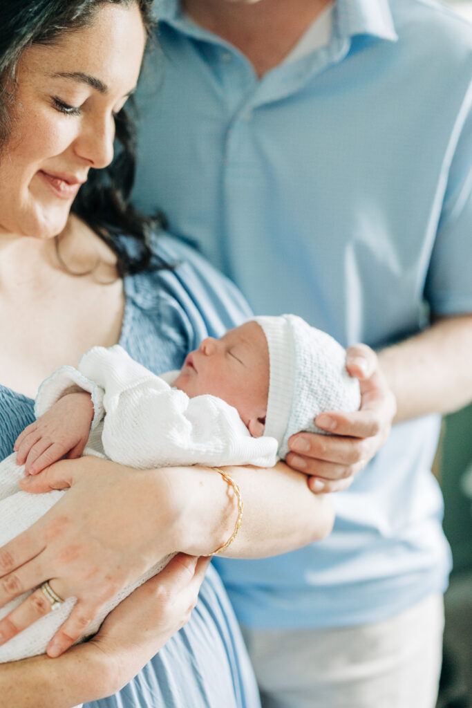 Close-up of newborn baby sleeping with parents during lifestyle newborn photography