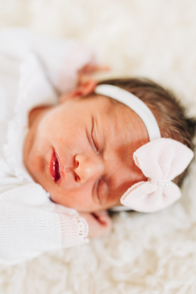 Close-up of newborn baby sleeping in a naturally posed photo shoot