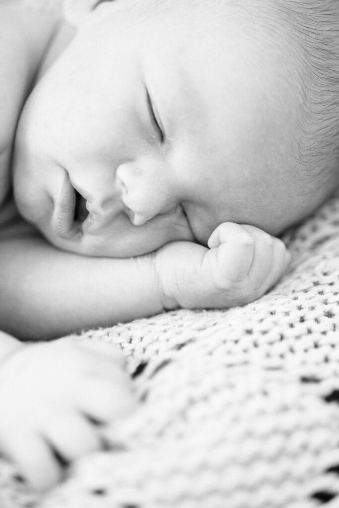 Close-up of newborn baby sleeping during a photo shoot with carters creative in South Carolina