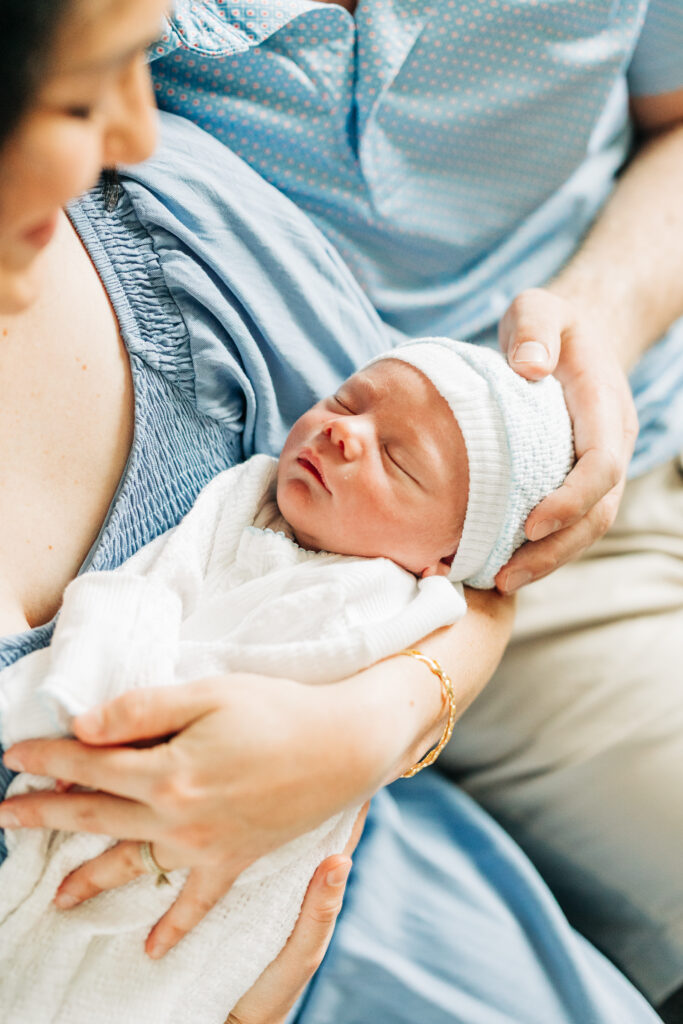 Close-up of newborn baby sleeping with parents during lifestyle newborn photography