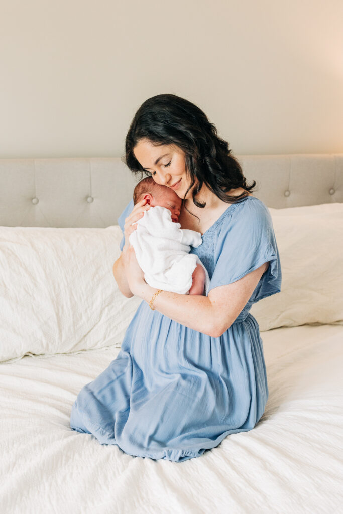 Close-up of newborn baby sleeping with mother during lifestyle newborn photography