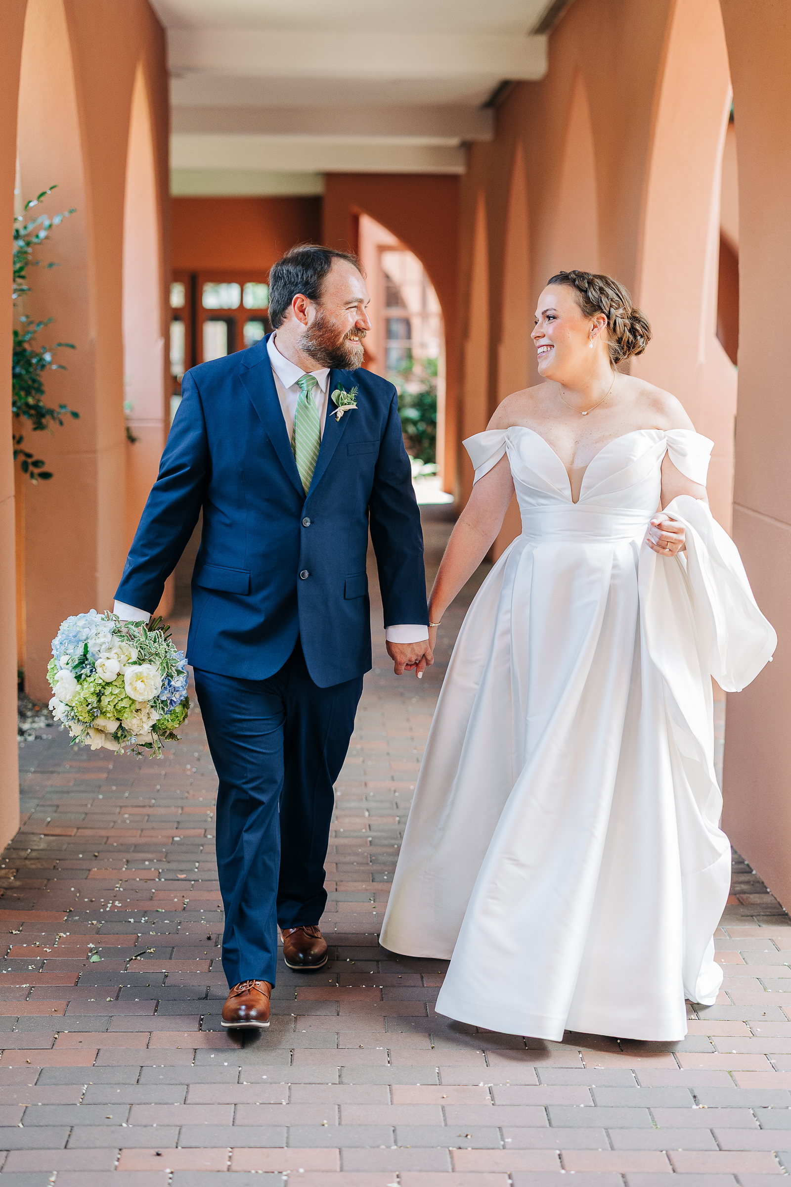 Bride and groom walk hand in hand on their wedding day at First Presbyterian Church