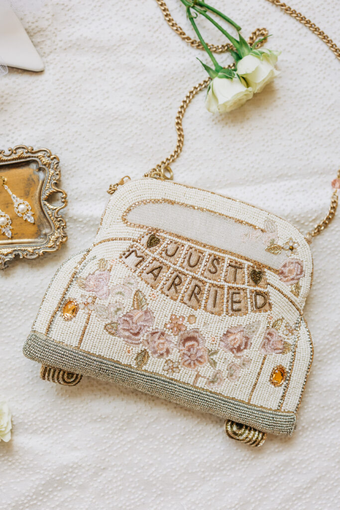 Flat lay wedding photo with "just married" purse for bride in South Carolina wedding