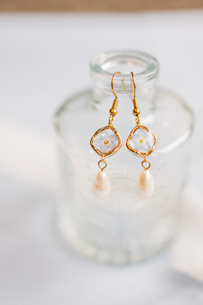 Flat lay detail of bridal earrings sentimental details from the bride