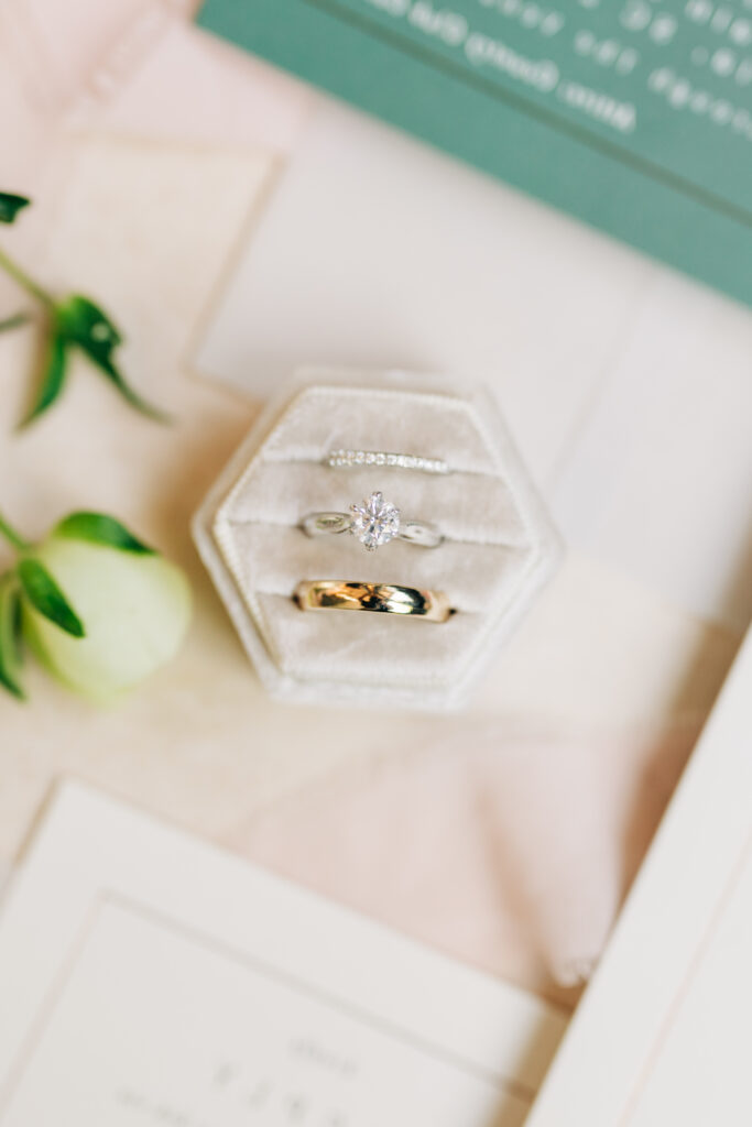 Wedding rings styled with neutral velvet ring box and textured linen image taken by south Carolina wedding photographers