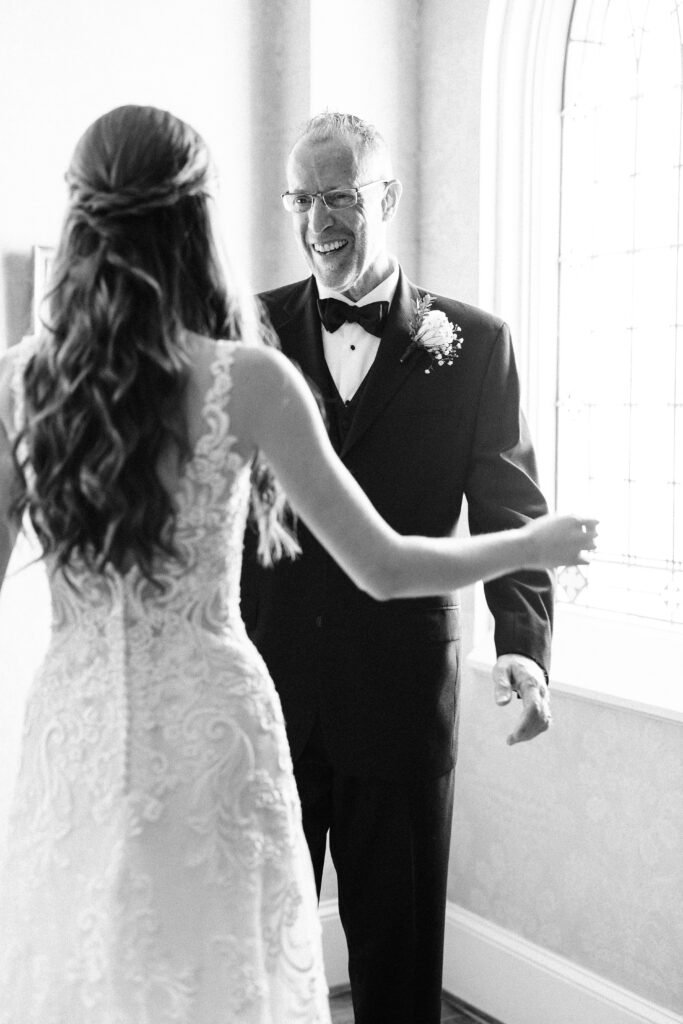 A joyful, emotional moment between a bride and her father on her wedding day