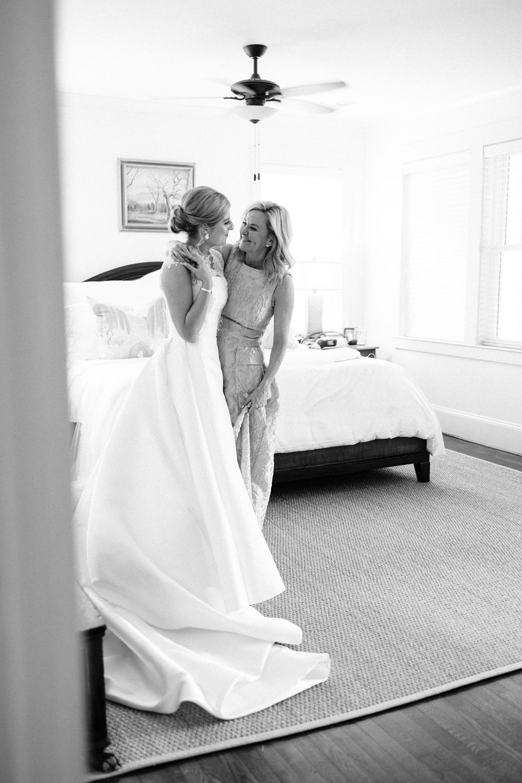 A joyful bride and her mother embracing