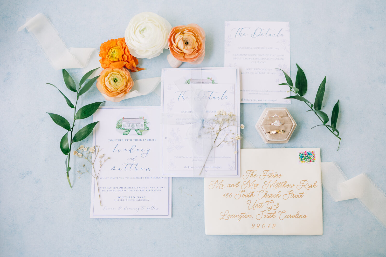 Flat lay of wedding rings and invites