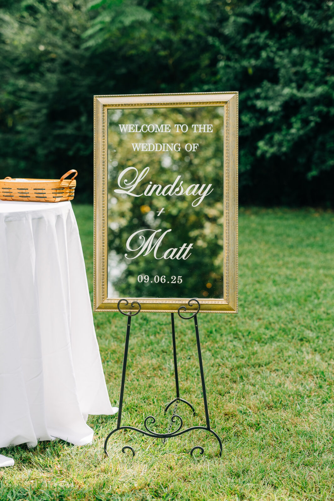 A close-up of wedding decor featuring a personalized welcome sign on a mirror– flat lay wedding photography