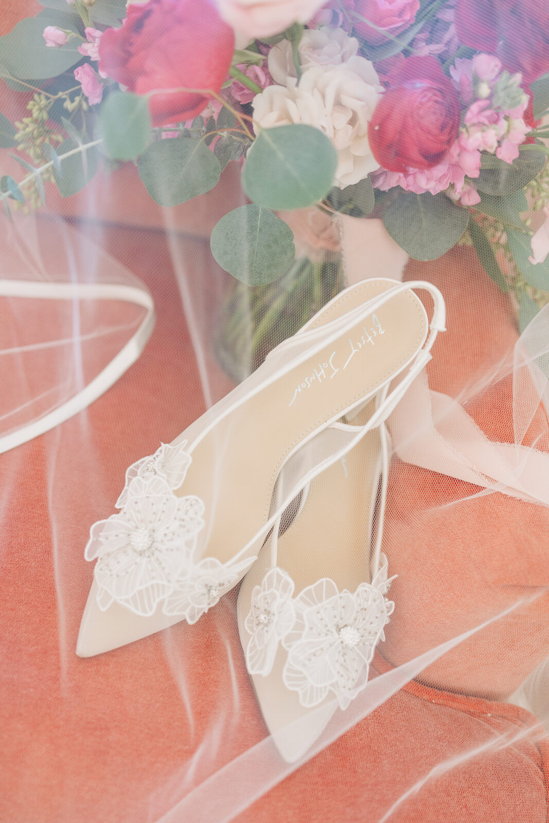 Close-up of the happy couple toasting with champagne and a vibrant bouquet in Columbia, SC