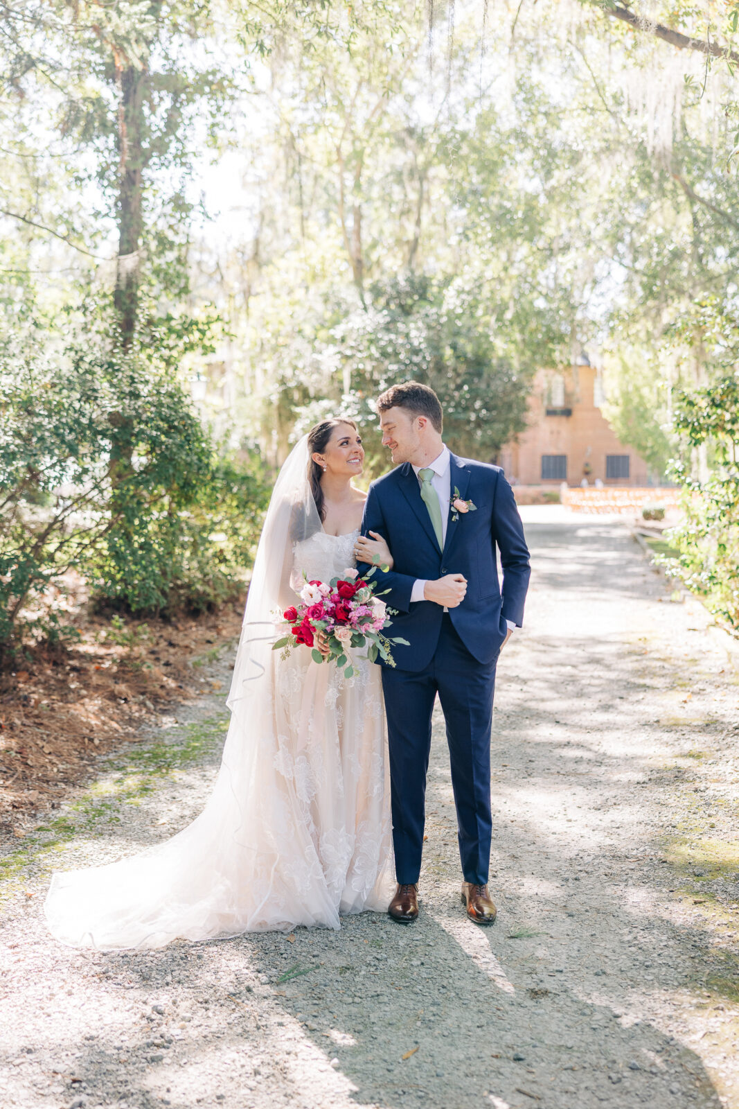 Happy couple walking on the scenic pathway toward the main house at The Millstone at Adams Pond