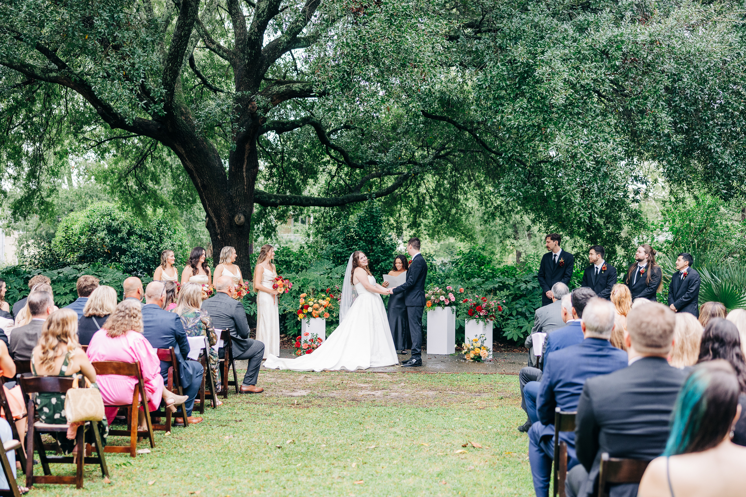 Outdoor wedding ceremony under a large oak tree at Hampton-Preston Mansion Gardens, Columbia, SC