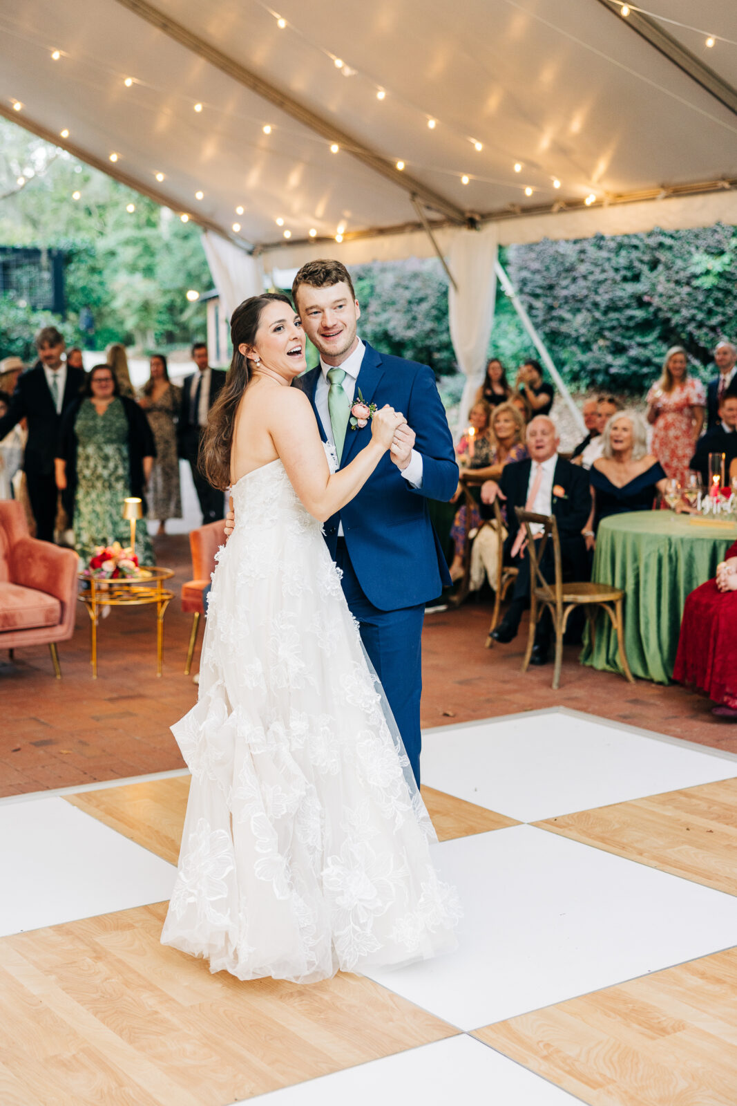 Close-up of a smiling bride embracing her groom from behind during outdoor wedding portraits in Columbia, SC
