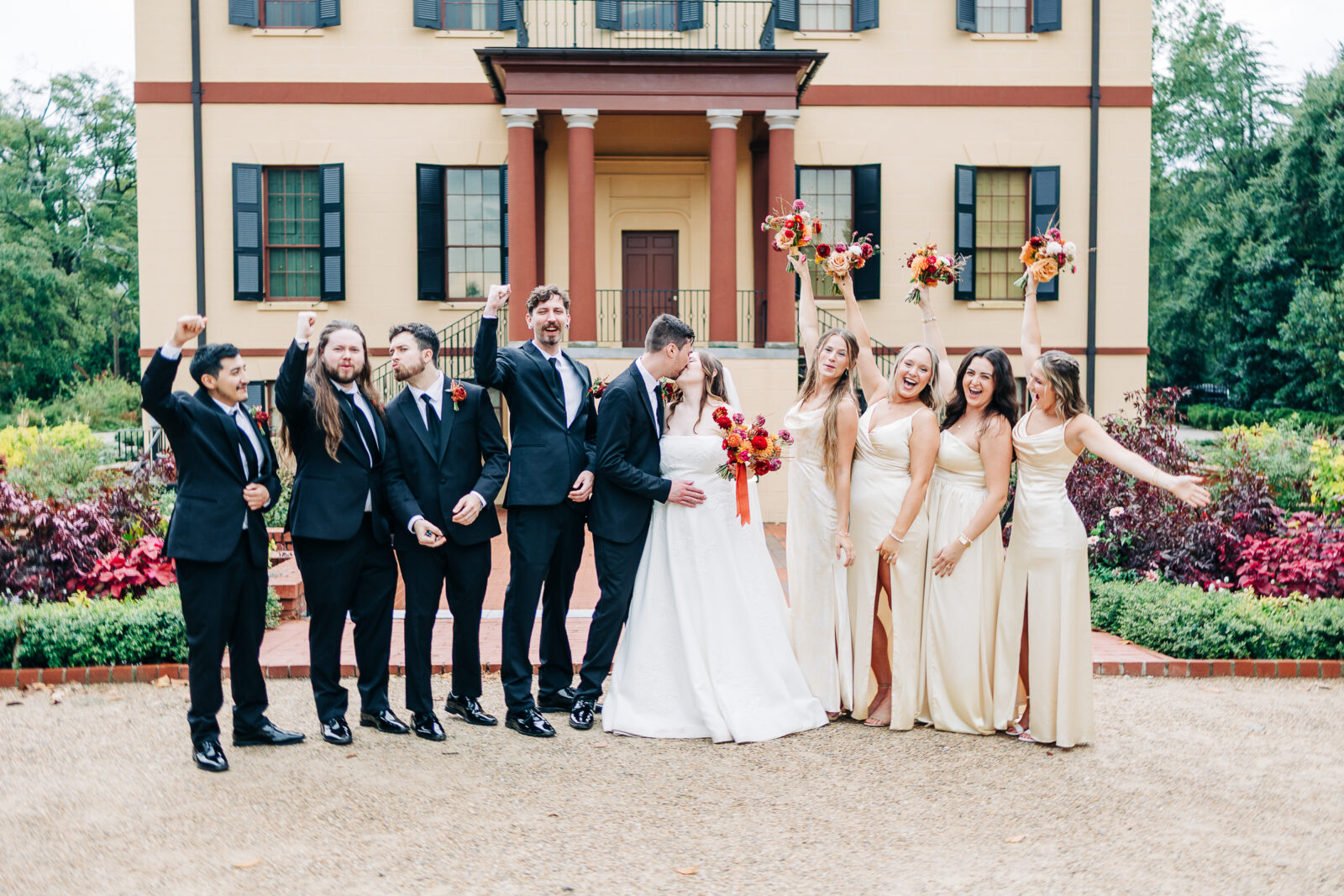 Full wedding party celebrating in front of the Hampton-Preston Mansion in Columbia, SC