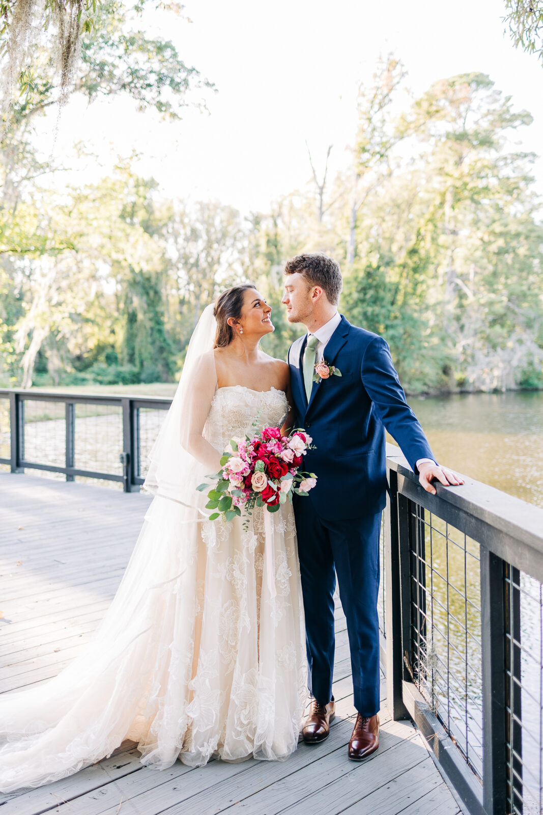 Romantic bride and groom portrait on a wooden deck by the water in Columbia, SC