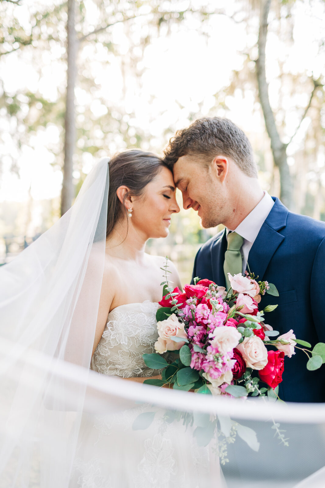 Close-up photo of the happy couple embracing during sunset portraits at The Millstone at Adams Pond