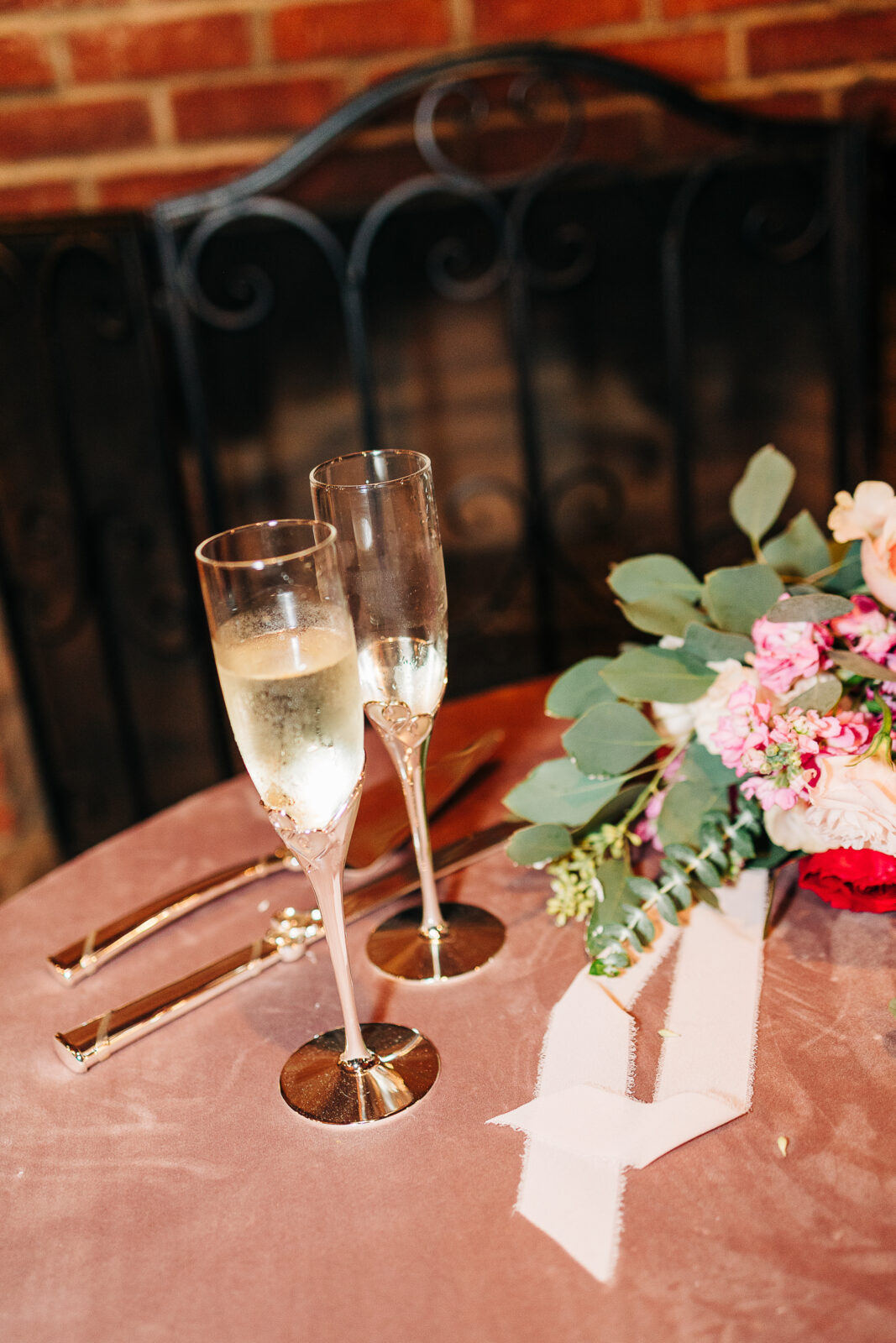 Romantic wedding reception detail shot with champagne, flowers, and elegant place settings in Columbia, SC