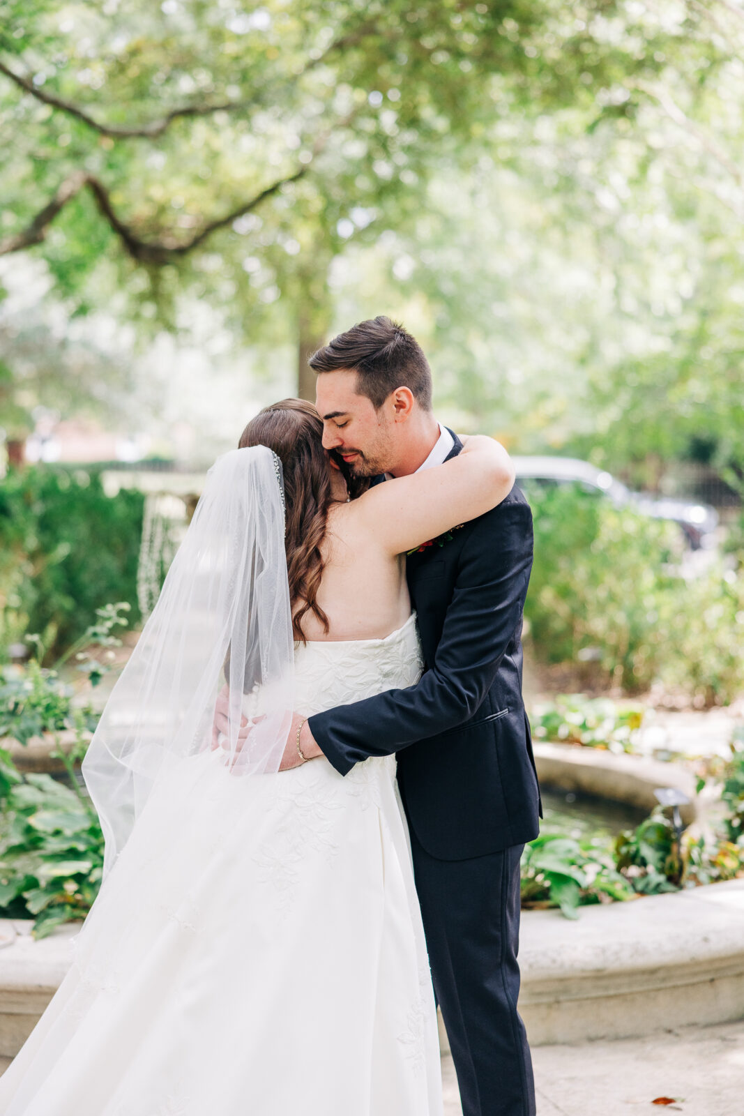 Tender moment with bride and groom embracing in the Hampton-Preston Mansion garden, Columbia, SC