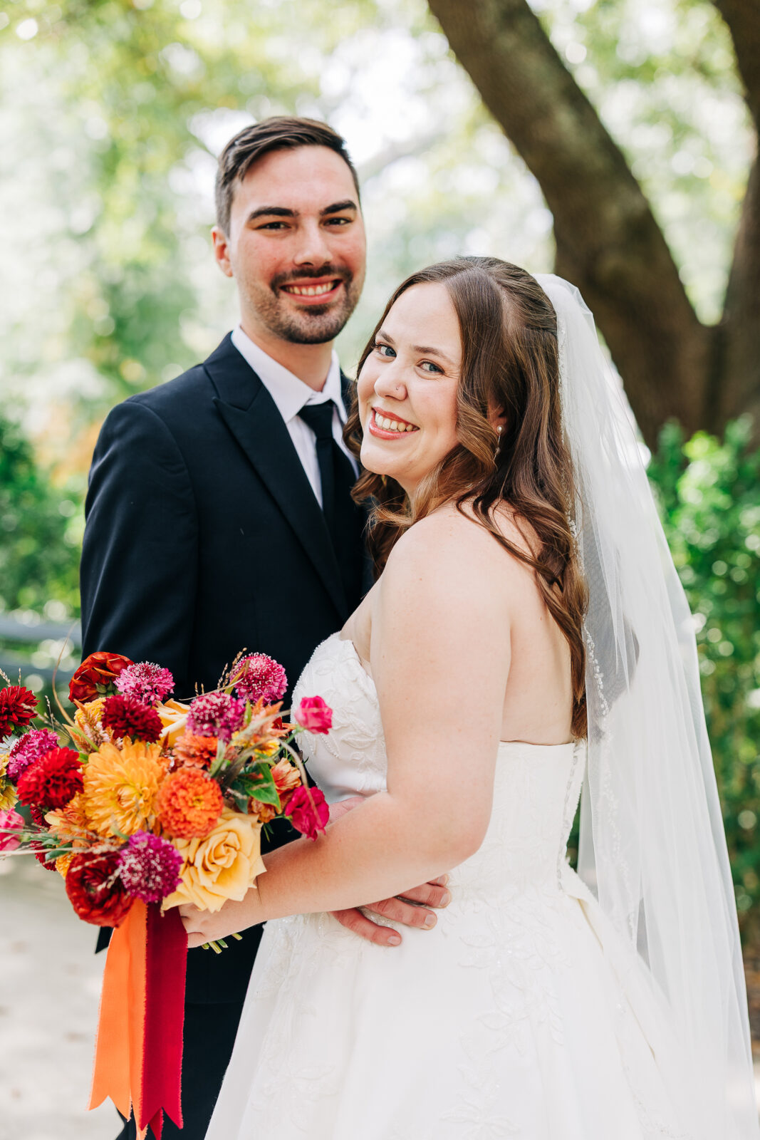 Bride and groom smiling at their colorful garden wedding at Hampton-Preston Mansion, Columbia, SC