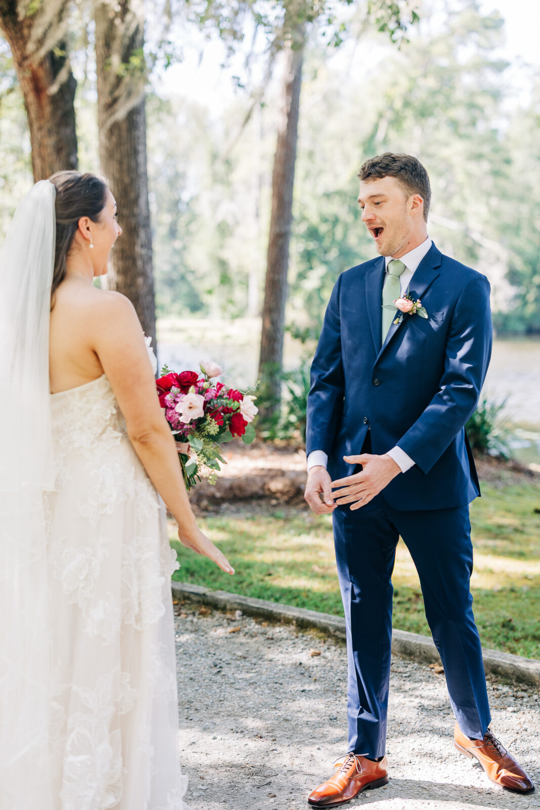 Groom's excited first look reaction to the bride on a wooded path in Columbia, SC