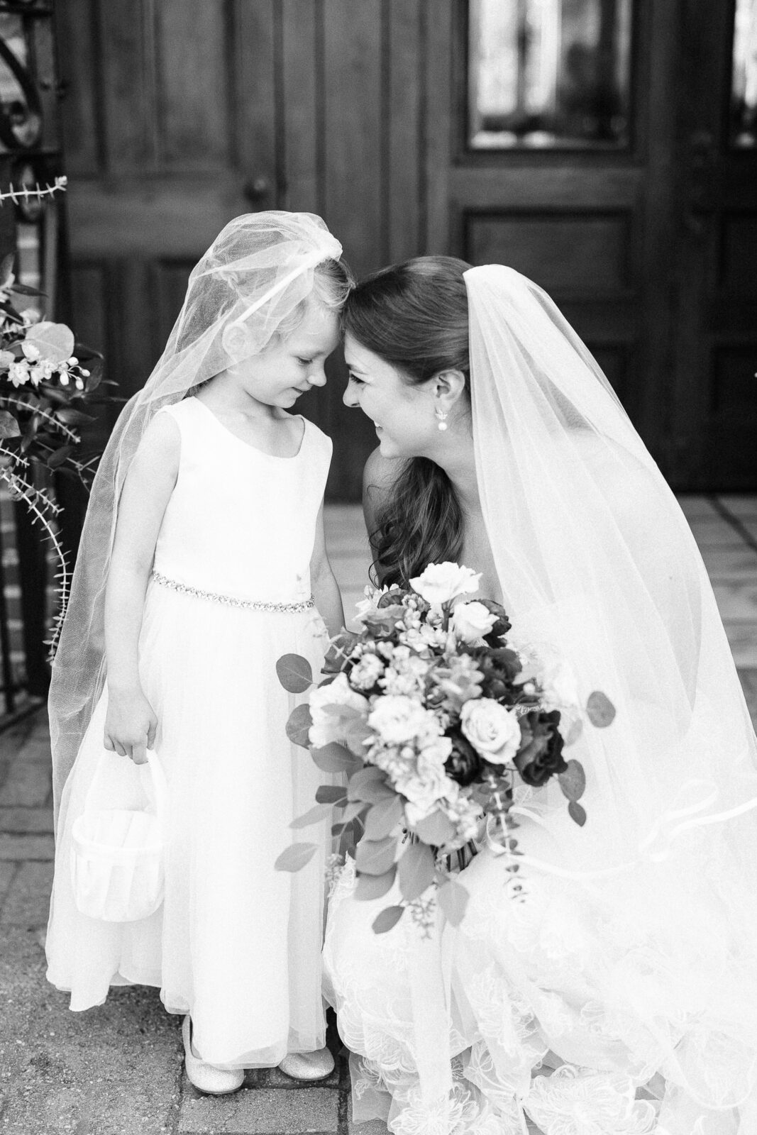 olumbia SC wedding photographer captures sweet bride and flower girl portrait with a cascading bouquet in black and white