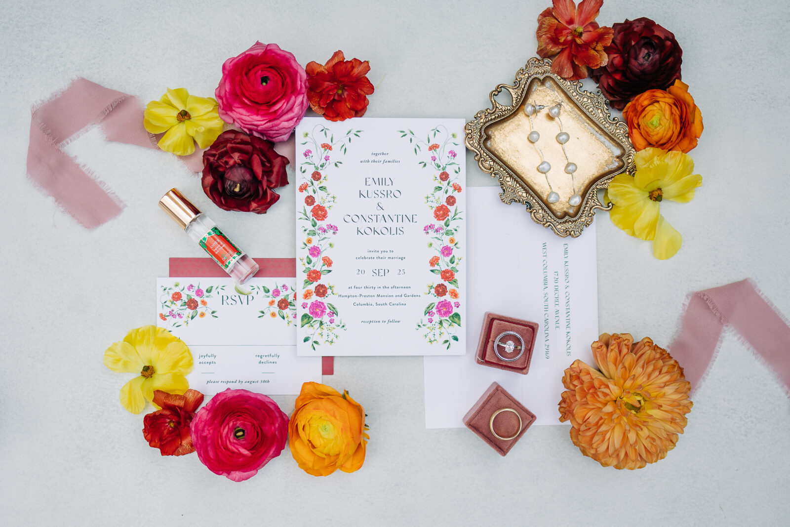 Flat lay of colorful floral wedding invitations and rings for Hampton-Preston Mansion and Gardens wedding in Columbia, SC