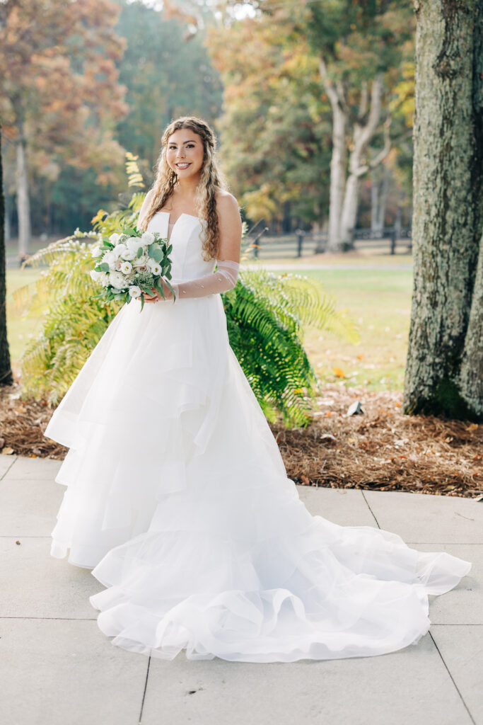 Full-length portrait of bride in layered ball gown with long train at Oakbrook Farms Wedding South Carolina