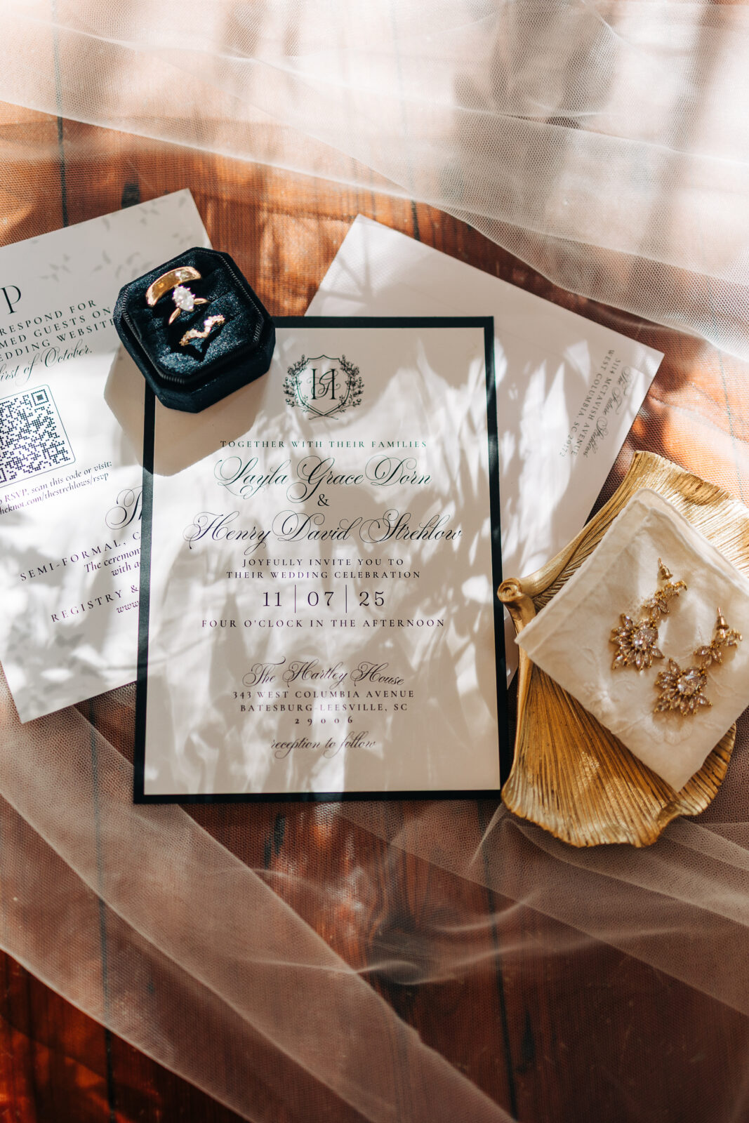 Full-length photo of the bride and groom sharing a soft kiss next to a small, ornate stone fountain on the lawn of the Hartley House Wedding South Carolina