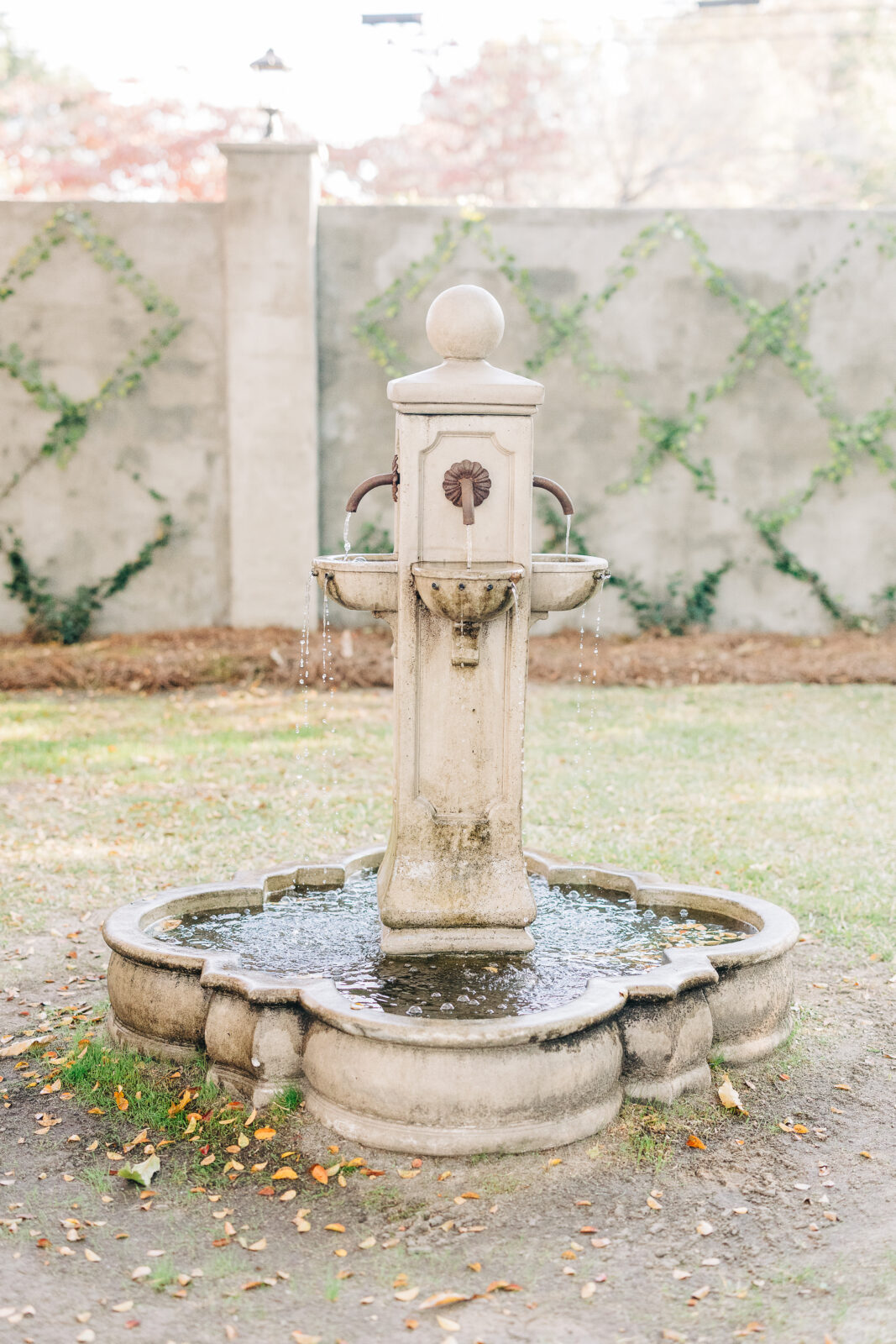 Full shot of the picturesque stone fountain, running with water, situated in the courtyard