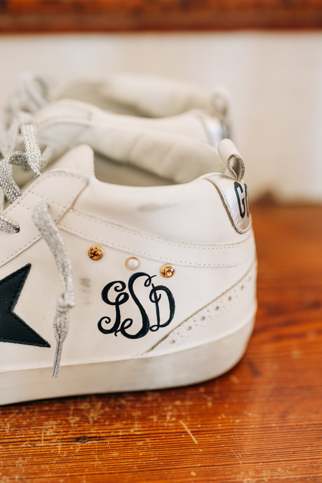 bride's white leather sneakers with metallic accents and her custom embroidered monogram (GSD) for the Hartley House Wedding South Carolina