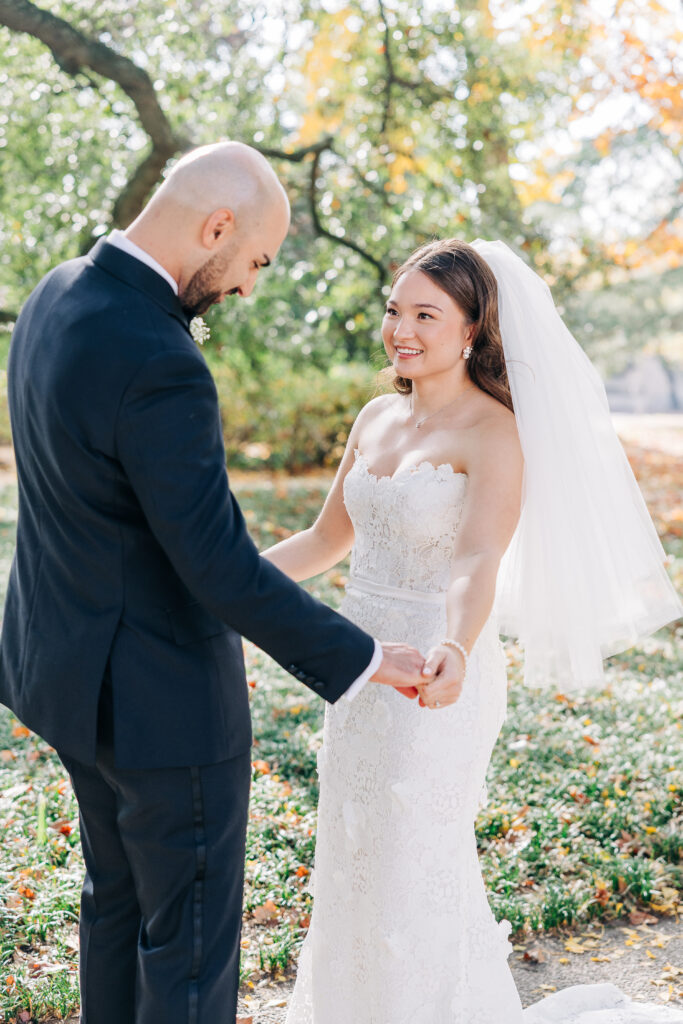 Bride and groom sharing a joyful first look moment in the garden at 1208 Washington Place.