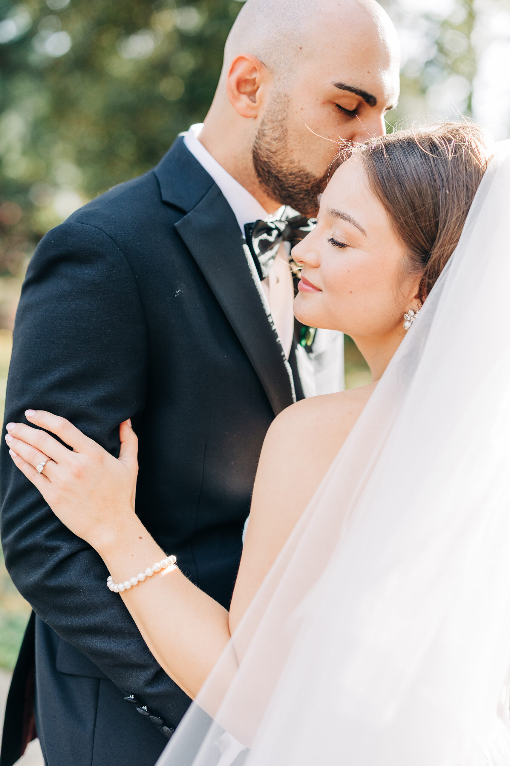 Emily and Bradley sharing a romantic nighttime kiss outside of 1208 washington place, a South Carolina wedding venue.
