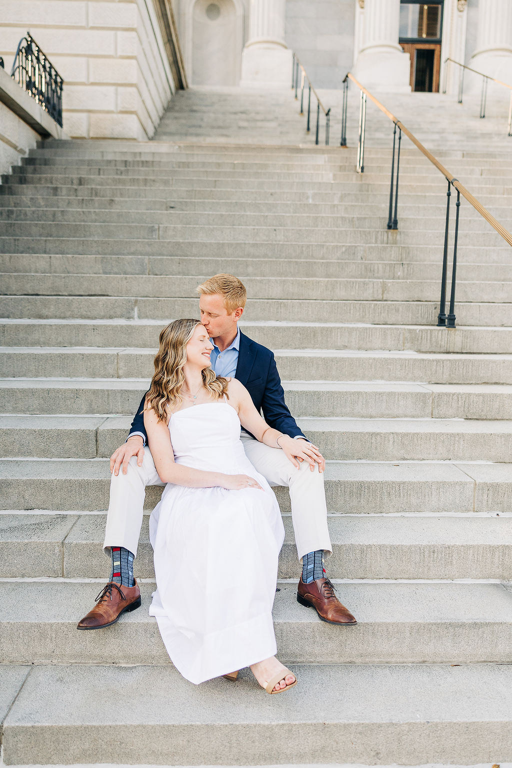 Couple sitting on the South Carolina State House steps during a classic Columbia engagement session