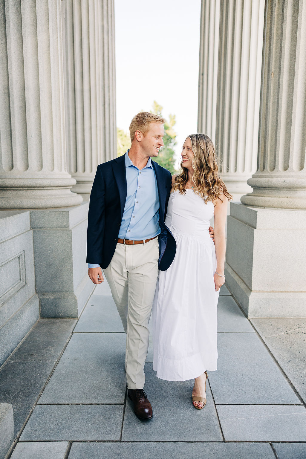 Engagement photos between grand columns at the South Carolina State House in Columbia SC