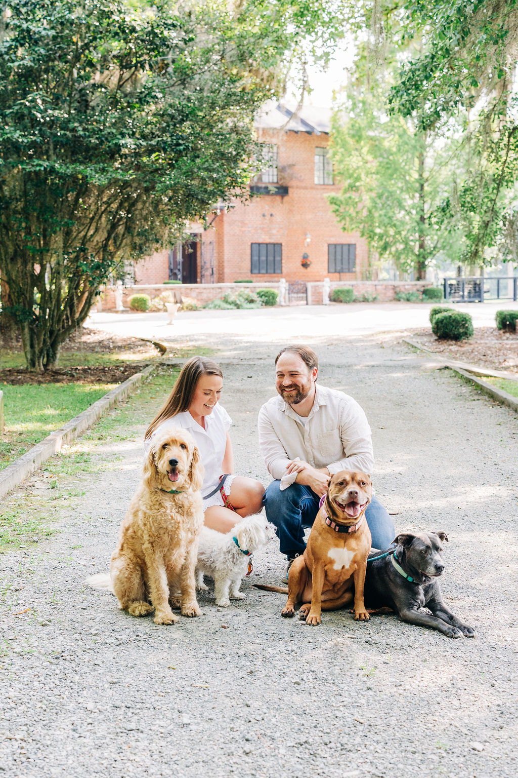 Couple with their dogs during a relaxed engagement session at a private farm near Columbia