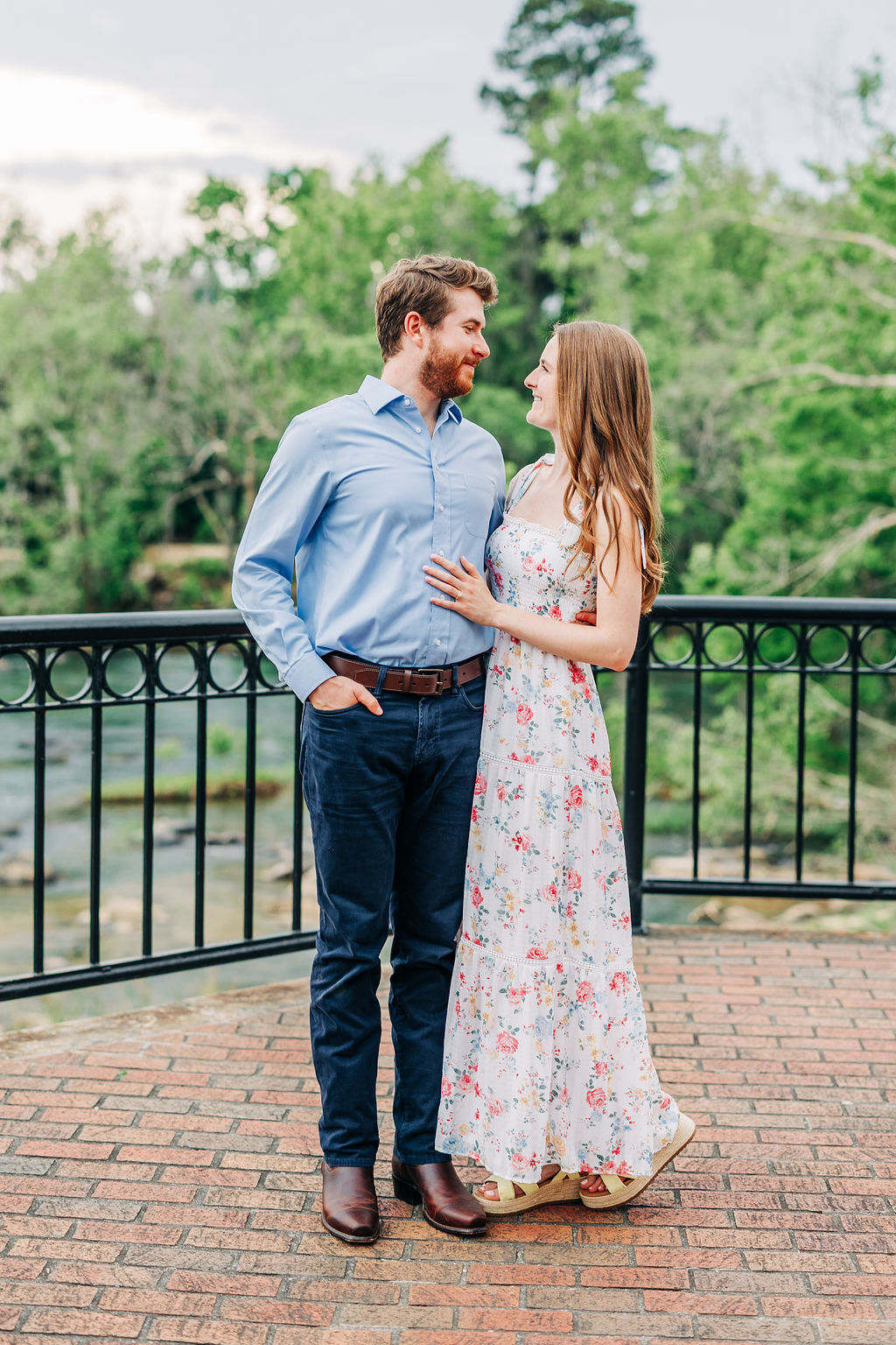Riverwalk engagement photos in Columbia SC with scenic water and greenery in the background