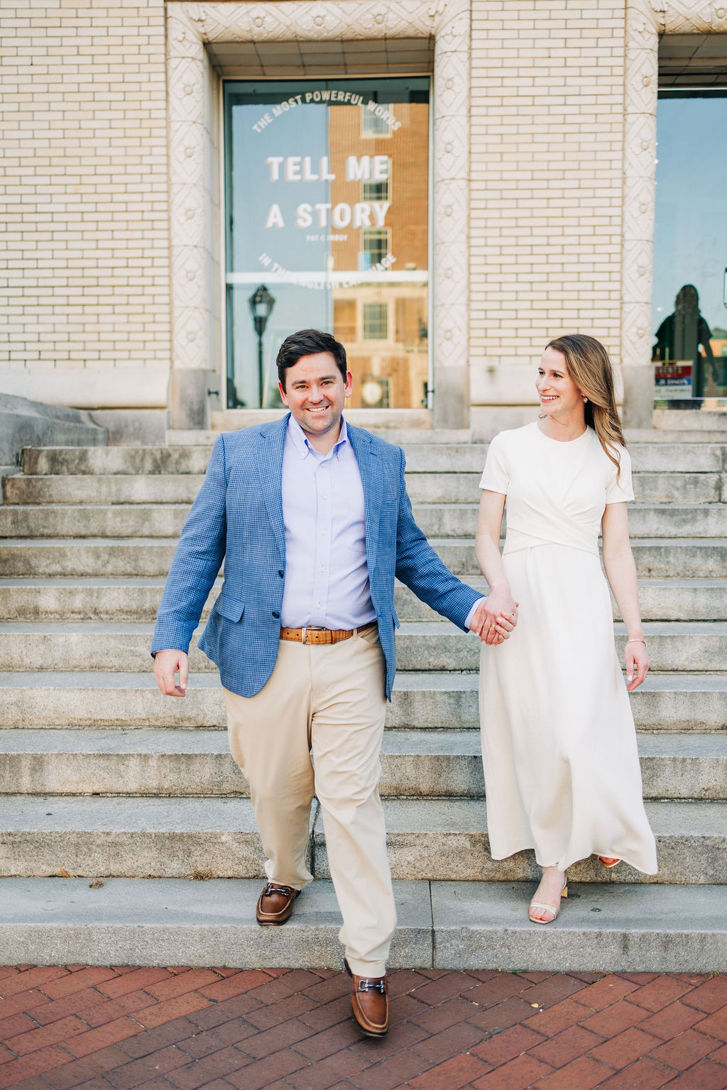 Charleston engagement photos with a couple standing on a quiet downtown street lined with palm trees