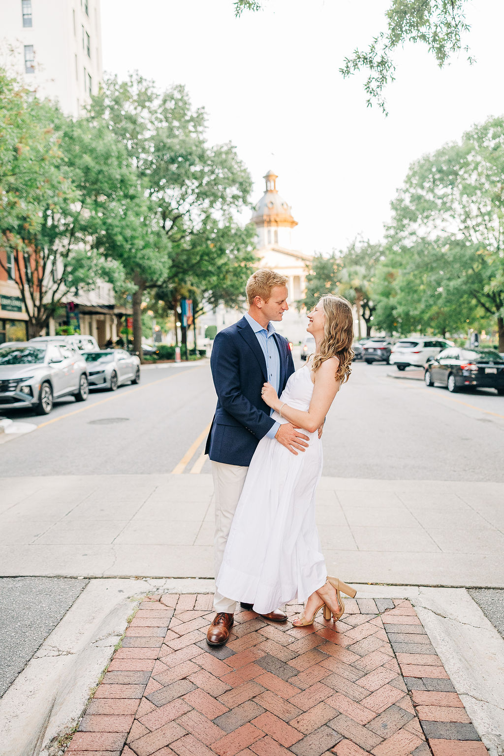 Romantic engagement photo in downtown Columbia SC with the State House softly blurred in the background
