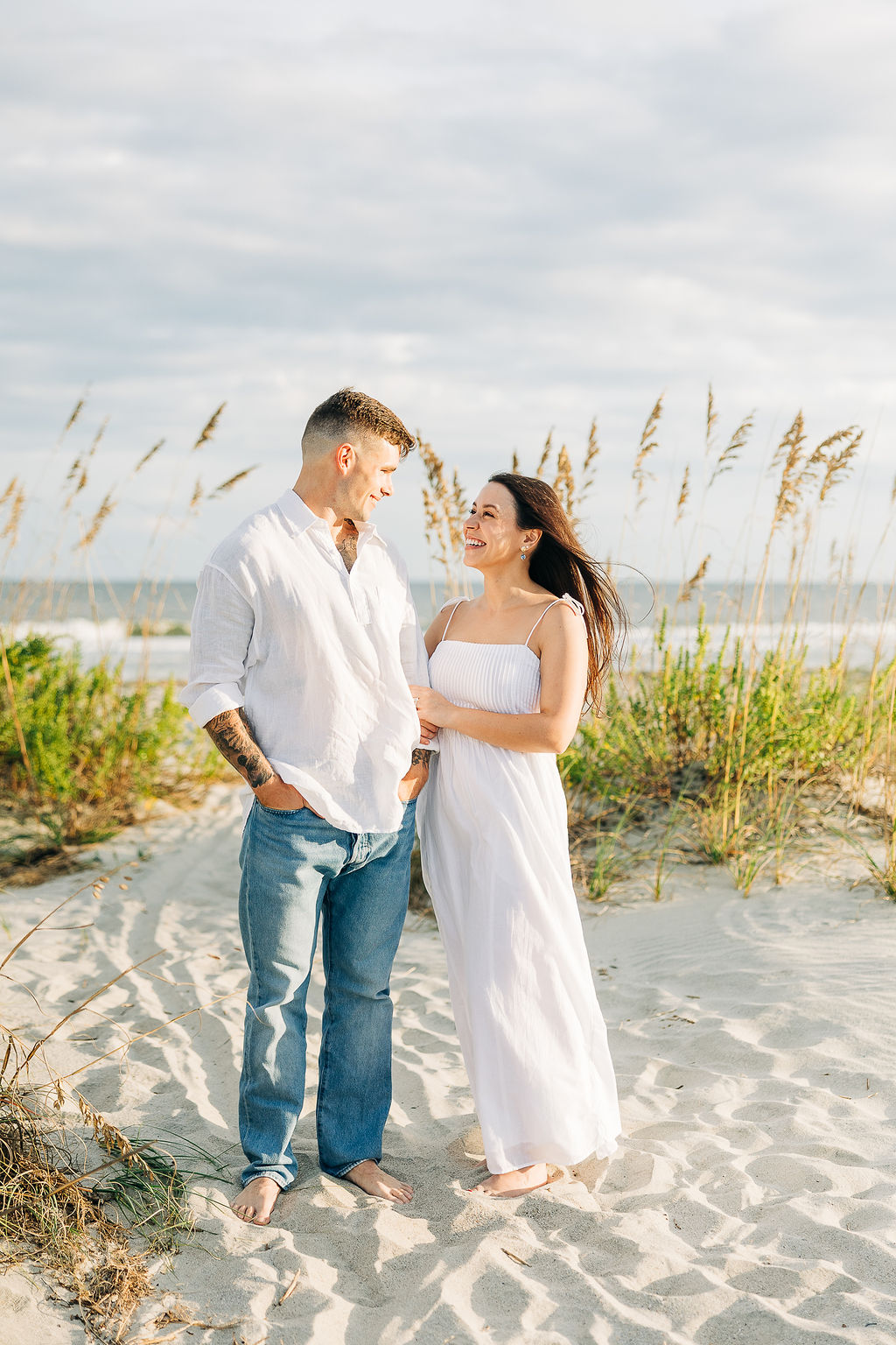 Couple walking barefoot along the beach during a relaxed South Carolina engagement session