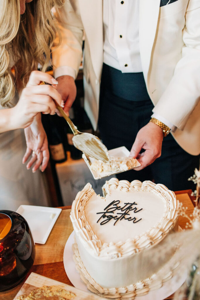 intimate photo of bride and groom cutting wedding cake